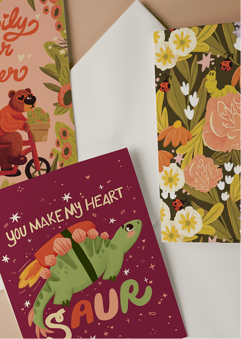 Three greeting cards with different designs on a flat surface