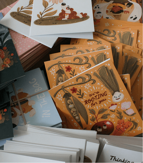 Collection of illustrated greeting cards with various designs and colors.