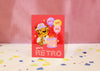 Greeting card with a retro-themed illustration of a leopard and balloons on a red background.