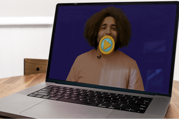 Laptop displaying a person in a video on a blue screen.