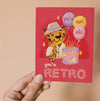 Greeting card with a retro-themed illustration of a leopard and balloons on a red background.
