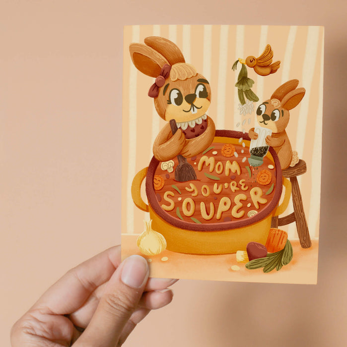 Greeting card with a mom and baby bunny and a pot labeled 'Mom, you're souper'.
