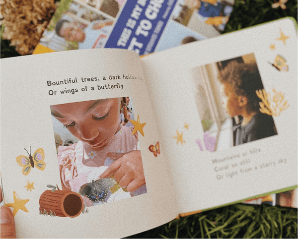 Open book with children's illustrations and text on a grassy background