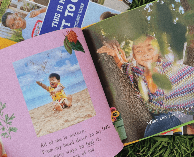 Children's books with colorful covers and images of children on a grassy background
