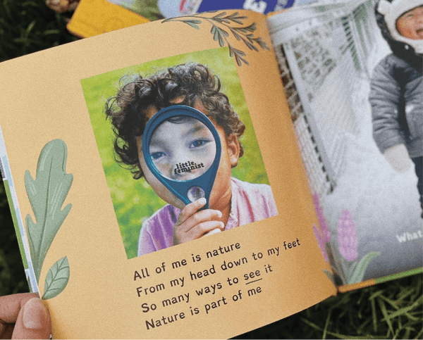 Children's book open to a page with a child holding a magnifying glass and nature-themed text.