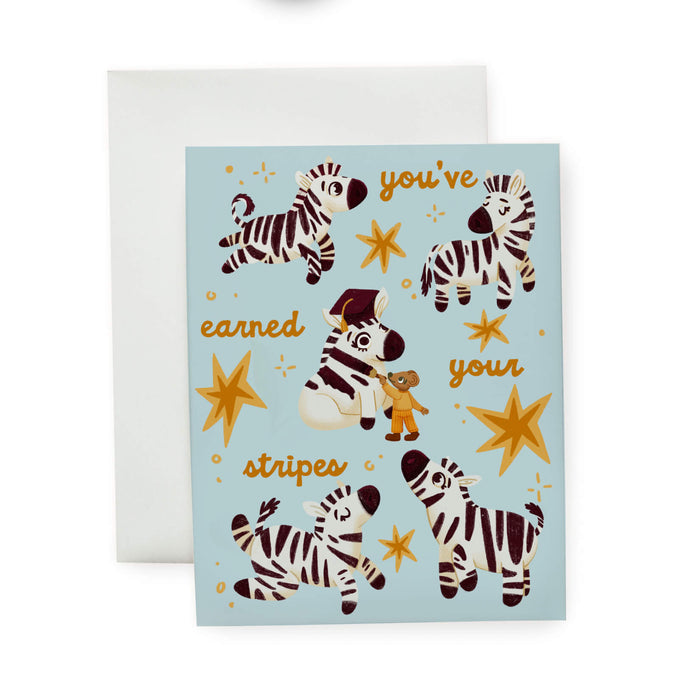 Graduation greeting card featuring stars and joyful zebras surrounding a white horse having it's stripes painted on by a little mouse.
