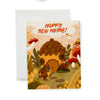 Greeting card with an acorn house, bear, owl, bird, and squirrel in a forest setting with 'Happy New Home!' text.